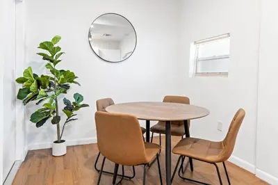 a dining room with a table and chairs and a mirror at Stylish 2BR/2BA Miami Home near Wynwood in Miami