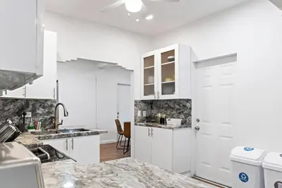a kitchen with white cabinets and a counter top at Stylish 2BR/2BA Miami Home near Wynwood in Miami