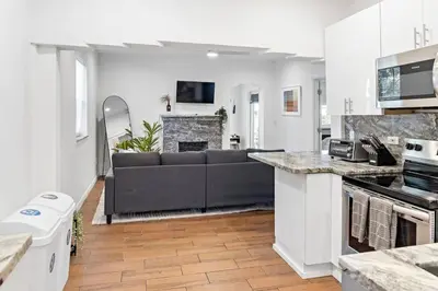 a living room with a couch and a fireplace at Stylish 2BR/2BA Miami Home near Wynwood in Miami
