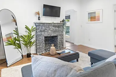 a living room with a fireplace and a tv at Stylish 2BR/2BA Miami Home near Wynwood in Miami