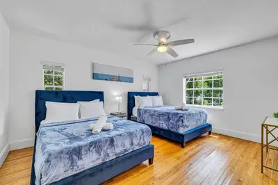 a bedroom with two beds and a ceiling fan at Stunning Tropical Getaway Steps To The Beach with Pool in Hollywood