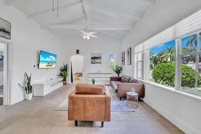 a living room with a couch and a chair at Stunning Tropical Getaway Steps To The Beach with Pool in Hollywood