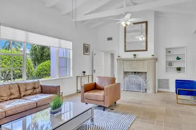 a living room with a couch and a fireplace at Stunning Tropical Getaway Steps To The Beach with Pool in Hollywood