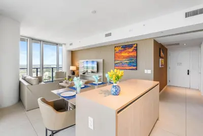 a kitchen and living room with a table and a couch at Corner Penthouse Ocean and City View in Hollywood