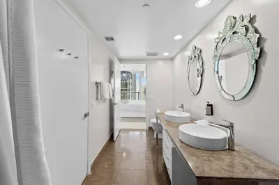 a white bathroom with two sinks and a mirror at Luxury Waterfront Brickell ICON W-Hotel Balcony Water Views in Miami