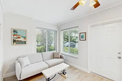 a living room with a white couch and a window at The Front House in Fort Lauderdale