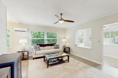 a living room with a couch and a ceiling fan at The Front House & Cottage in Fort Lauderdale