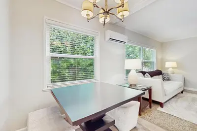 a living room with a table and a couch at The Cottage in Fort Lauderdale