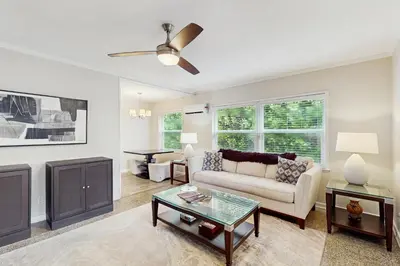 a living room with a couch and a table at The Cottage in Fort Lauderdale