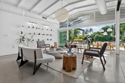 a living room with a lot of chairs and tables at Isla Solana by Rove Travel - Waterfront with Pool in Miami