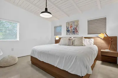 a bedroom with a large bed with white sheets at Isla Solana by Rove Travel - Waterfront with Pool in Miami