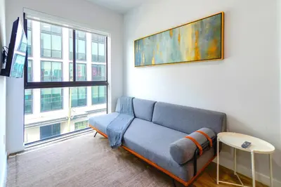 a living room with a couch and a large window at Wynwood Retreat - Rooftop Pool & Neighborhood Views in Miami