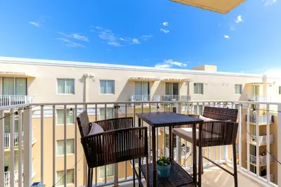 a balcony with a table and chairs and a building at 1 Bedroom Apt With Patio in South Riverside in Miami