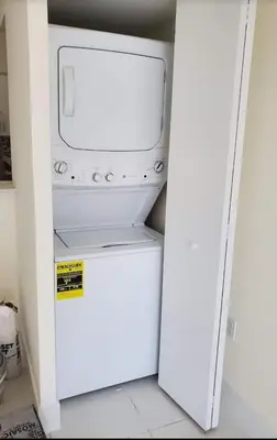 a white refrigerator with a microwave inside of it at 1 Bedroom Apt With Patio in South Riverside in Miami