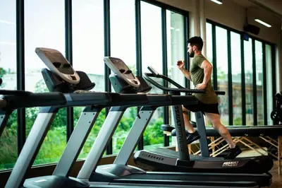 a man running on a treadmill in a gym at 1 Bedroom Apt With Patio in South Riverside in Miami
