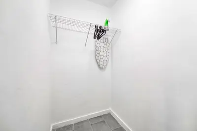 a white wall with a rack of hooks on it at Modern Studio Retreat to Explore Miami in Miami