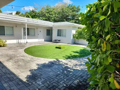 a house with a lawn in front of it at Modern Studio Retreat to Explore Miami in Miami