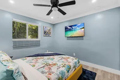 a bedroom with a bed and a ceiling fan at RJ Home Away From Home LLC in Miami Gardens
