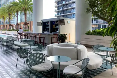 a patio with tables and chairs and a bar at GREAT STUDIO - Luxe Brickell Stay Near Bay in Miami