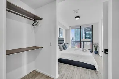a white bedroom with a bed and a large window at Waterline Corner Vies 2Br 2BA Suites in Miami