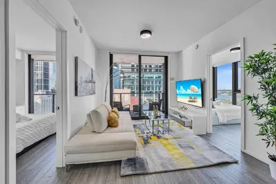 a living room with a couch and a tv at Waterline Corner Vies 2Br 2BA Suites in Miami