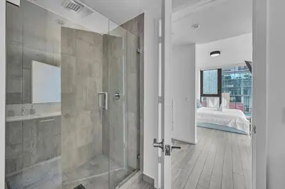 a bathroom with a shower and a bedroom with a bed at Waterline Corner Vies 2Br 2BA Suites in Miami