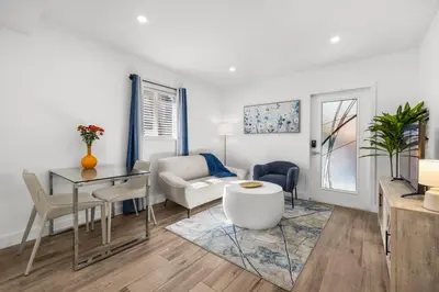 a living room with a table and a couch at Cozy By The Blue in Miami
