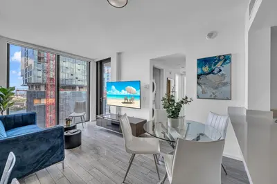 a living room with a glass table and chairs at Miami City Lights 2BR 2BA in Miami