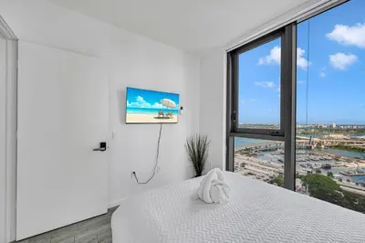 a bedroom with a bed and a large window at Miami City Lights 2BR 2BA in Miami