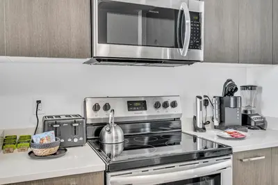a kitchen with a stove and a microwave at Miami City Lights 2BR 2BA in Miami