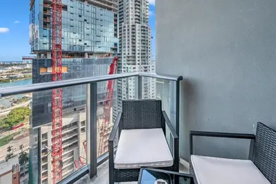 a balcony with a chair and a view of a city at Miami City Lights 2BR 2BA in Miami