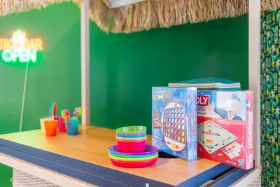 a table with some toys and a book on it at Large 12 Guest Home w Pool, Hollywood FL in Hollywood
