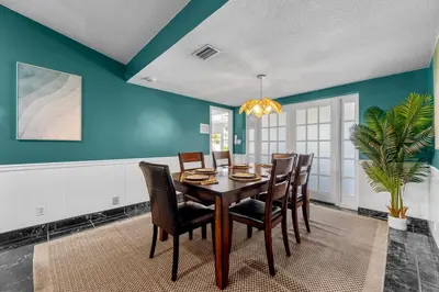 a dining room with a table and chairs at Large 12 Guest Home w Pool, Hollywood FL in Hollywood
