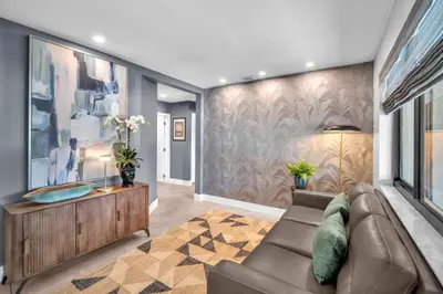 a living room with a couch and a wall at Almost Famous - Pool - Jacuzzi in Fort Lauderdale