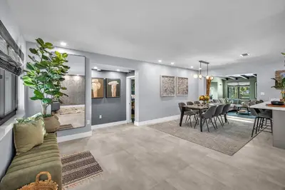 a dining room and living room with a dining table at Almost Famous - Pool - Jacuzzi in Fort Lauderdale