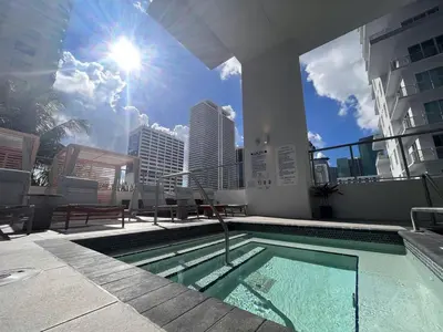 a swimming pool on the roof of a building at Skyline Nomad Studio Walk to Kaseya Rooftop Pool in Miami