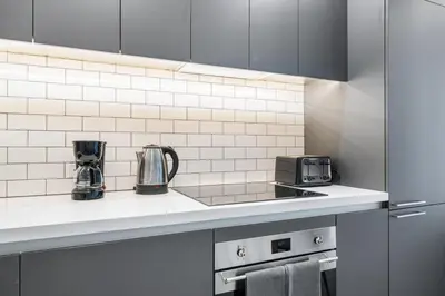 a kitchen with a counter top with a toaster and appliances at Skyline Nomad Studio Walk to Kaseya Rooftop Pool in Miami