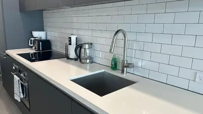 a kitchen counter top with a sink and a counter top at Skyline Studio Workspace & Rooftop Pool in Miami