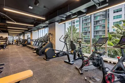 a gym with treadmills and cardio equipment in a building at Skyline Studio Workspace & Rooftop Pool in Miami