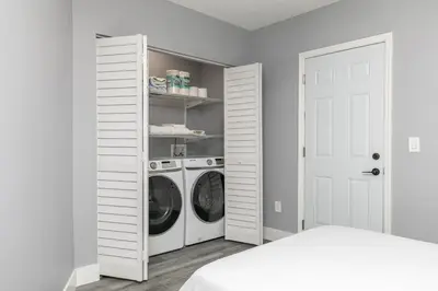 a white laundry room with a washer and dryer at Modern Miami Oasis with Pool & Water View in North Miami