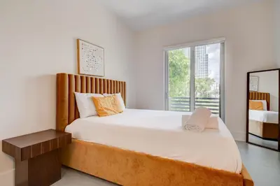 a bedroom with a large bed and a window at Lux Villa Sol in Miami