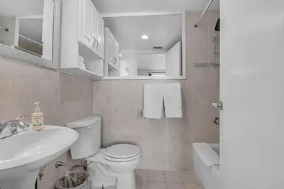 a bathroom with a white toilet and a sink at 1 BLOCK FROM OCEAN 1 Bedroom in South Beach Collins Avenue in Miami Beach
