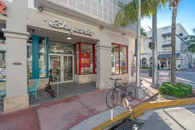 a bike parked on a sidewalk in front of a store at 1 BLOCK FROM OCEAN 1 Bedroom in South Beach Collins Avenue in Miami Beach
