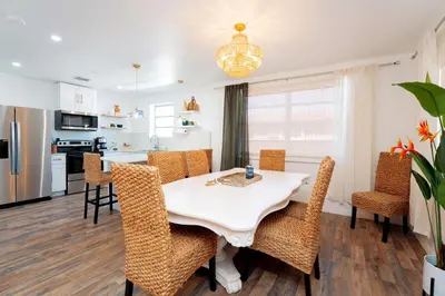 a kitchen and dining room with a table and chairs at Family Home Casa Del Rio - Unit A in Miami