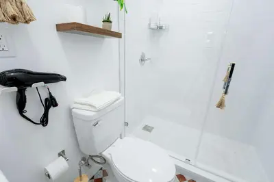a white bathroom with a shower and a toilet at Family Home Casa Del Rio - Unit A in Miami