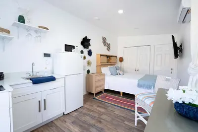 a kitchen and a bedroom with a bed and a table at Rio retreat - Unit B in Miami