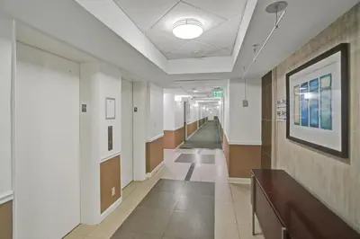 a hallway of an office building with a hallway at Oceanview 3BR Penthouse | Pool + Beach Access in Hallandale Beach
