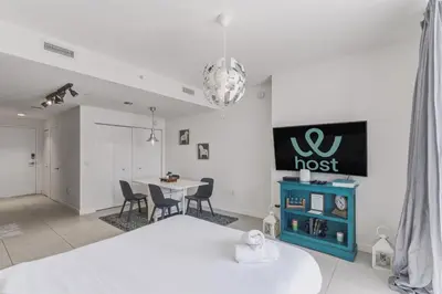 a bedroom with a bed and a table and chairs at Modern Studio in Downtown Doral in Miami