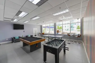 a room with two ping pong tables in a room at Luxury Suite | Sauna, Pool & Resort Access in Miami