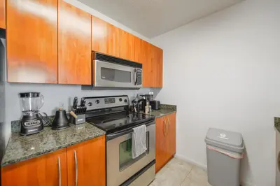a kitchen with a stove and a microwave at Luxury 2BD Condo | Sauna, Pool & Resort Access in Miami